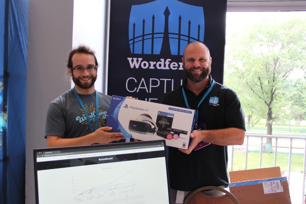 Photo of Matt Barry and Aaron Silber holding the first-place prize for the Wordfence CTF