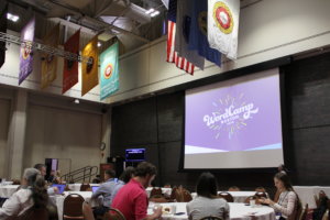 Photo of an audience and projection screen with the words "WordCamp Boston"