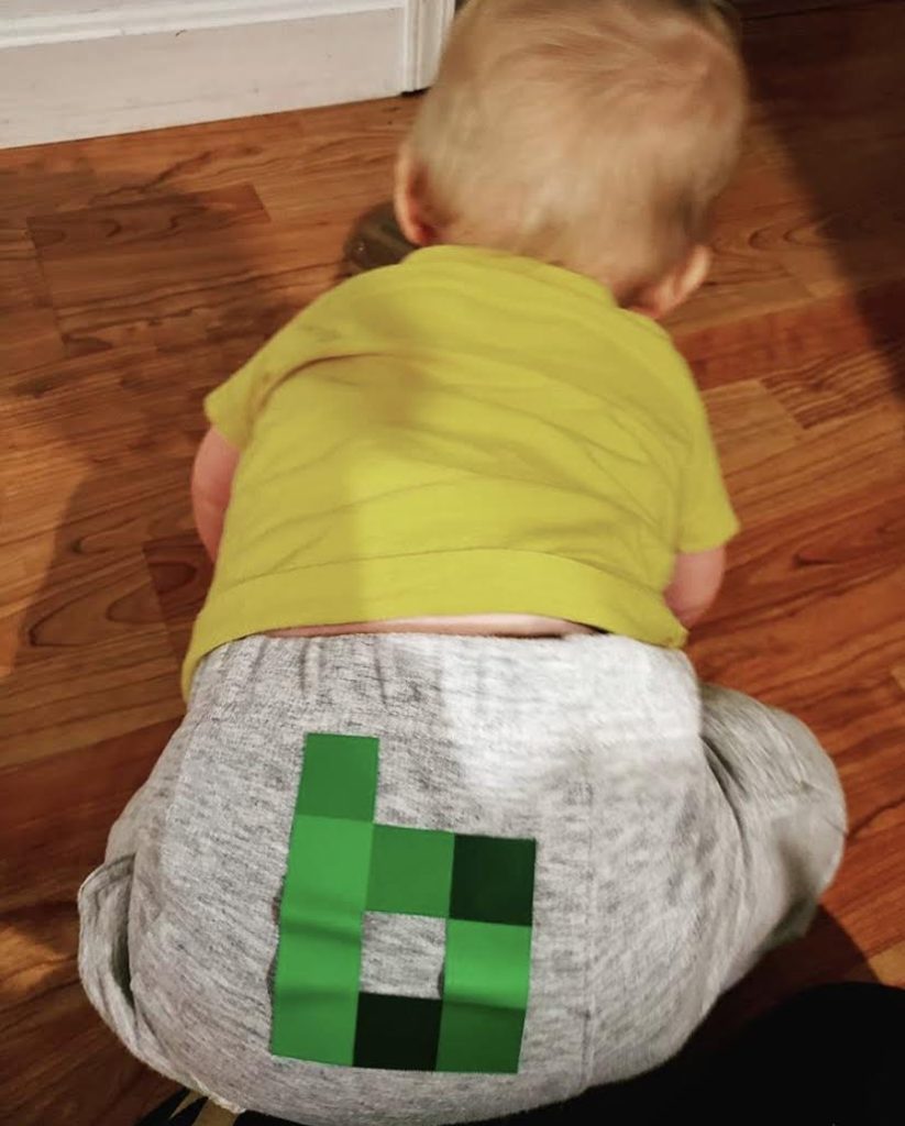 baby with a bytes sticker on it's butt