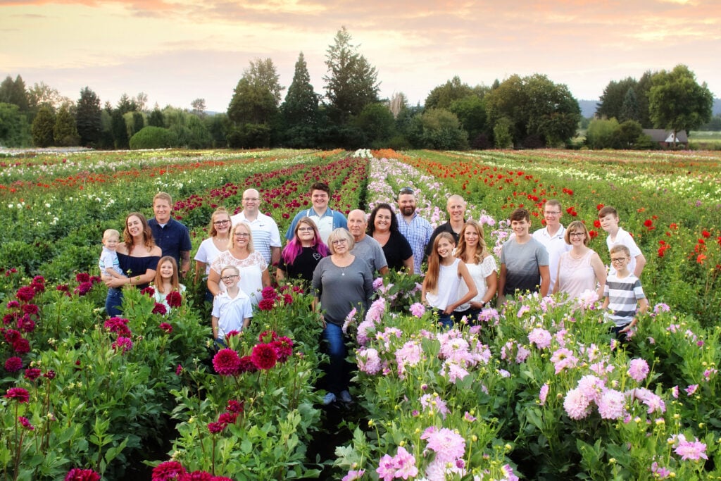 The Gitts family, owners of Swan Island Dahlias, are standing in a field of dahlias