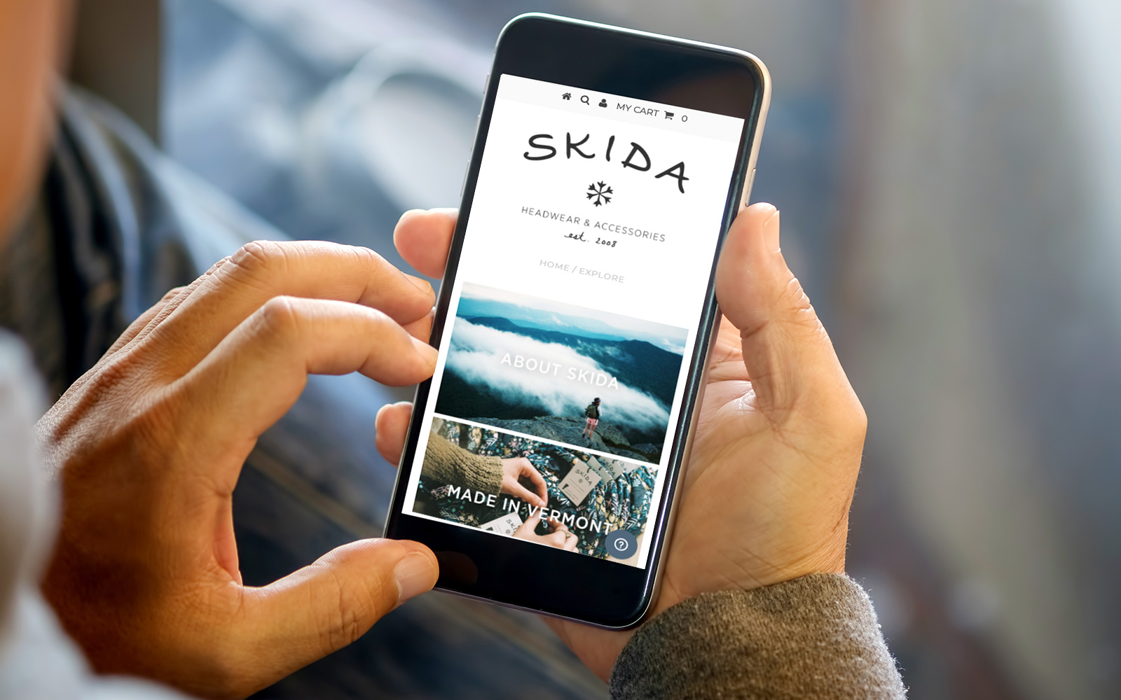 Man on a cellphone browsing the Explore page on the Skida website