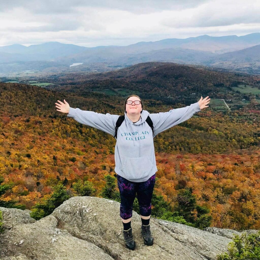 Hannah on top of a Vermont summit during fall foliage