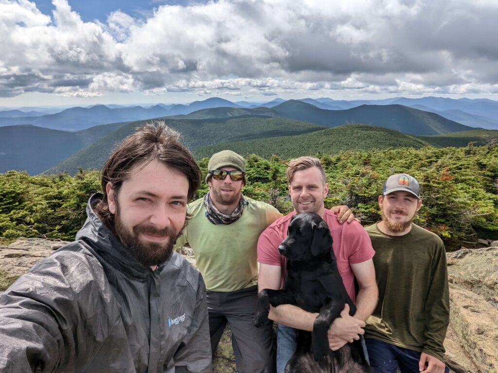 Photo of Eric and others on the summit of a hike