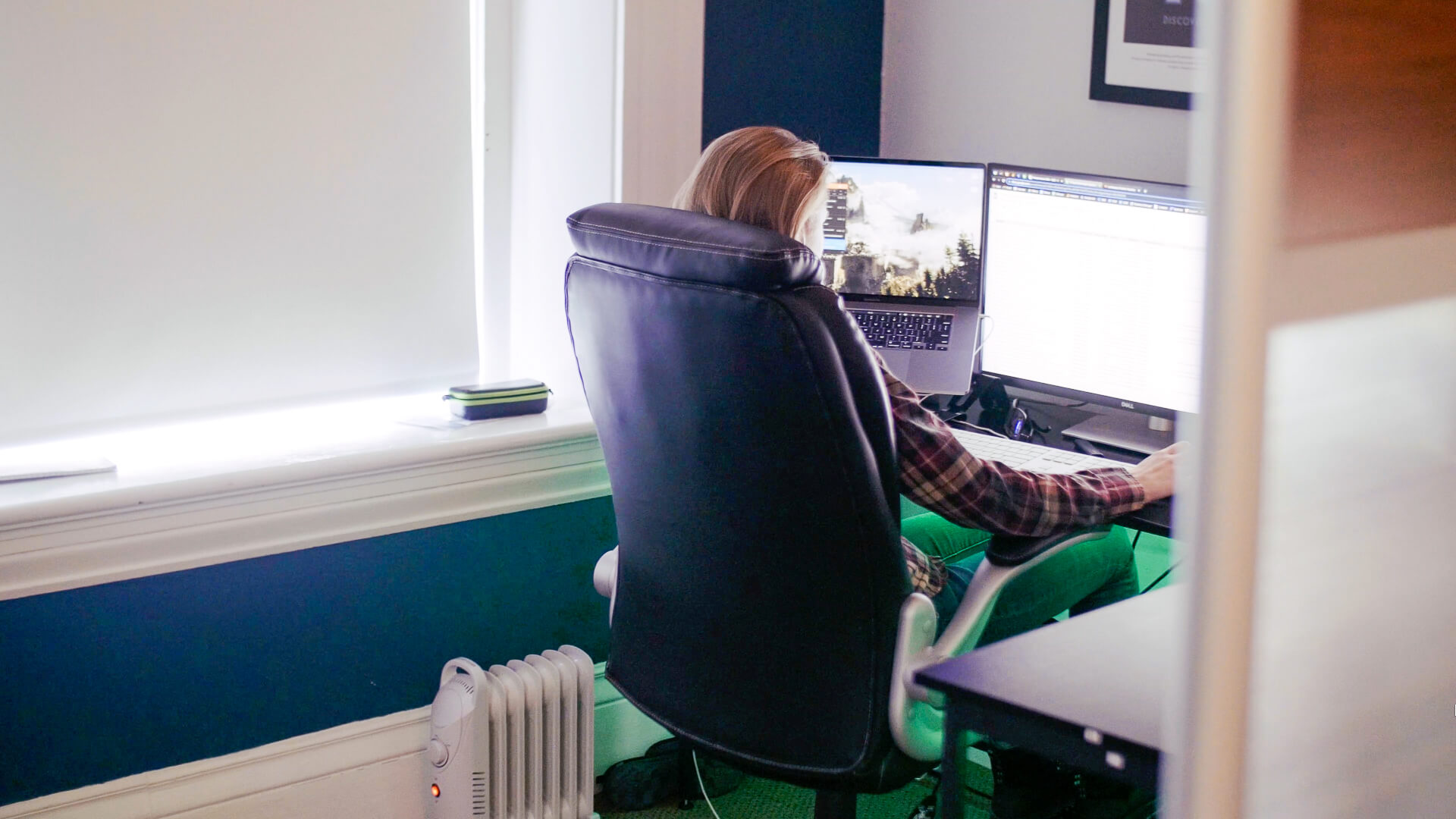 Person working on a computer sitting at a desk