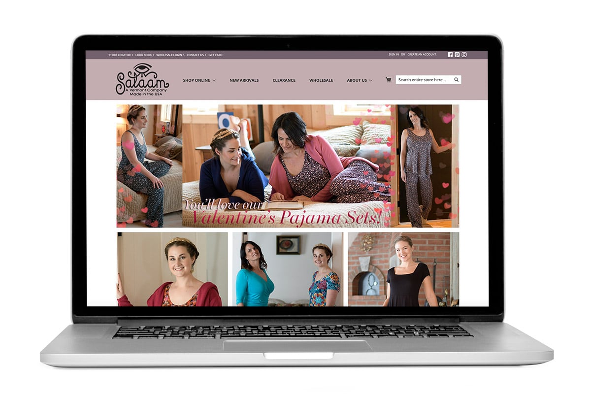 Laptop open on the homepage of the Salaam Clothing website, a Vermont-based retailer of women's clothing
