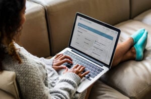 Woman on laptop doing using a WordPress banking website