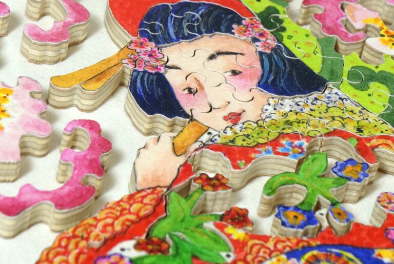 A handcrafted wooden Stave Puzzle featuring an Asian woman and cherry blossoms