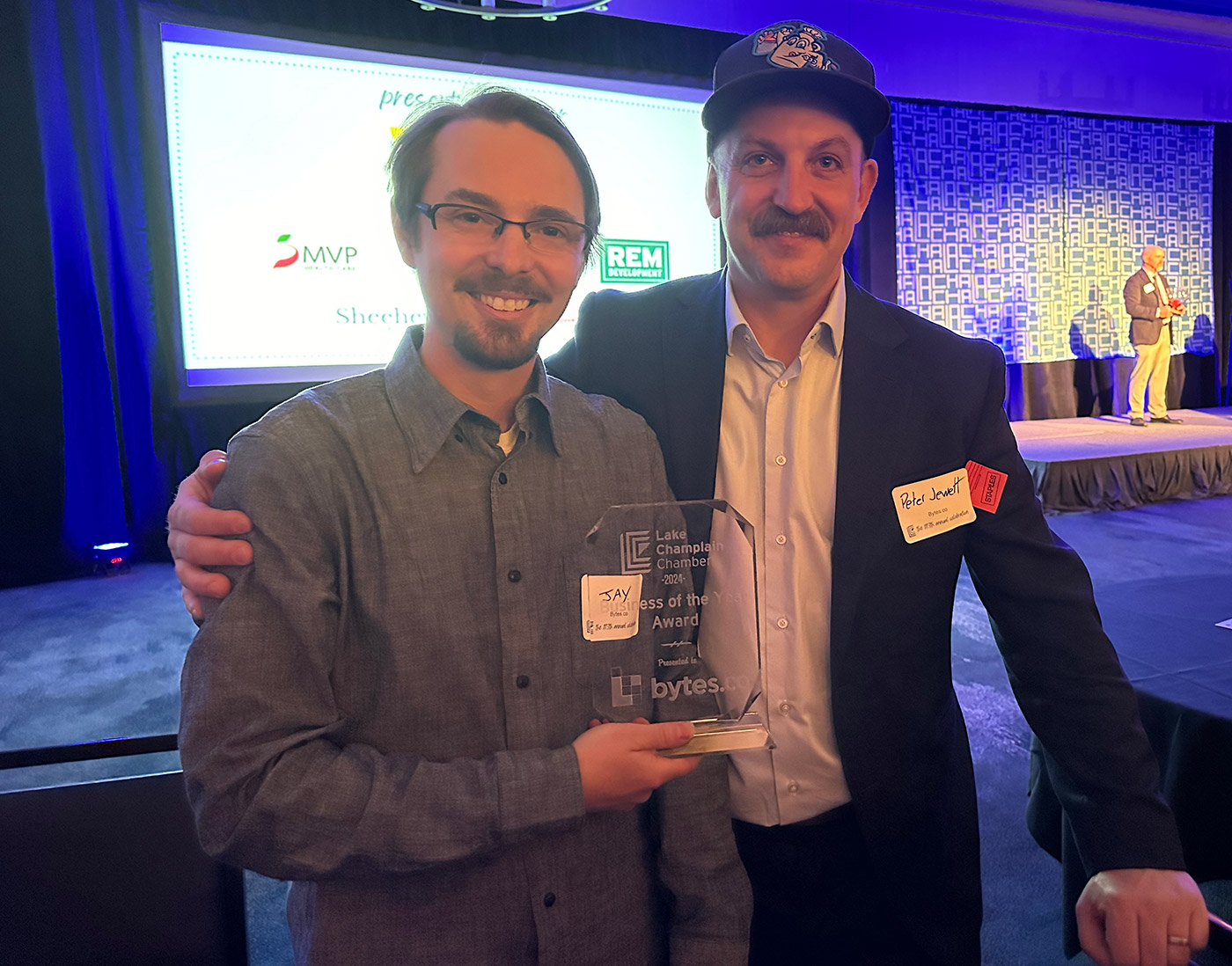 Bytes.co co-founders Jay Di Vece and Peter Jewett holding the 2024 Business of the Year award at the Lake Champlain Chamber's 113th Annual Dinner
