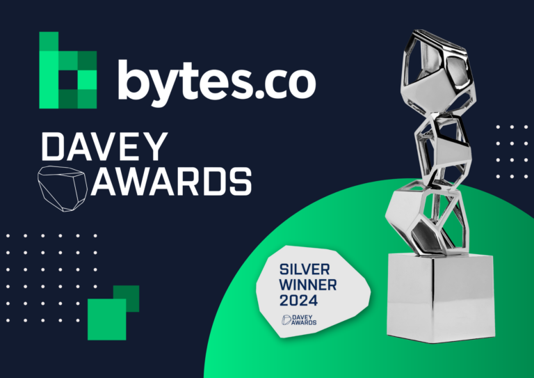 The Bytes.co and Davey Awards logos together next to the Silver 2024 Davey Awards winner logo and trophy statuette on a navy blue and green background