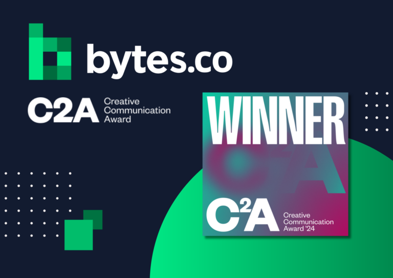 The Bytes.co and MarCom Awards logos together next to the 2024 C2A Creative Communication Awards winner logo on a navy blue and green background