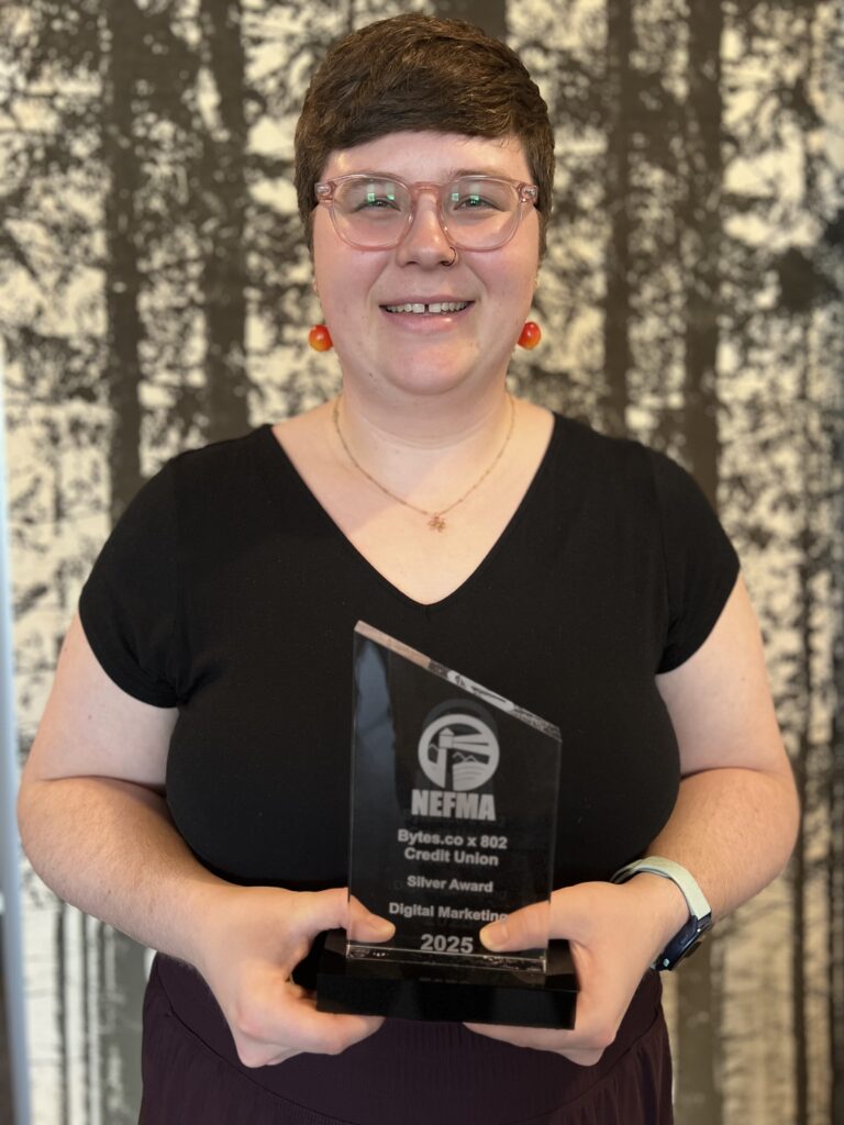Senior Digital Marketing Specialist Hannah Hook standing and holding the 2025 NEFFIE Award