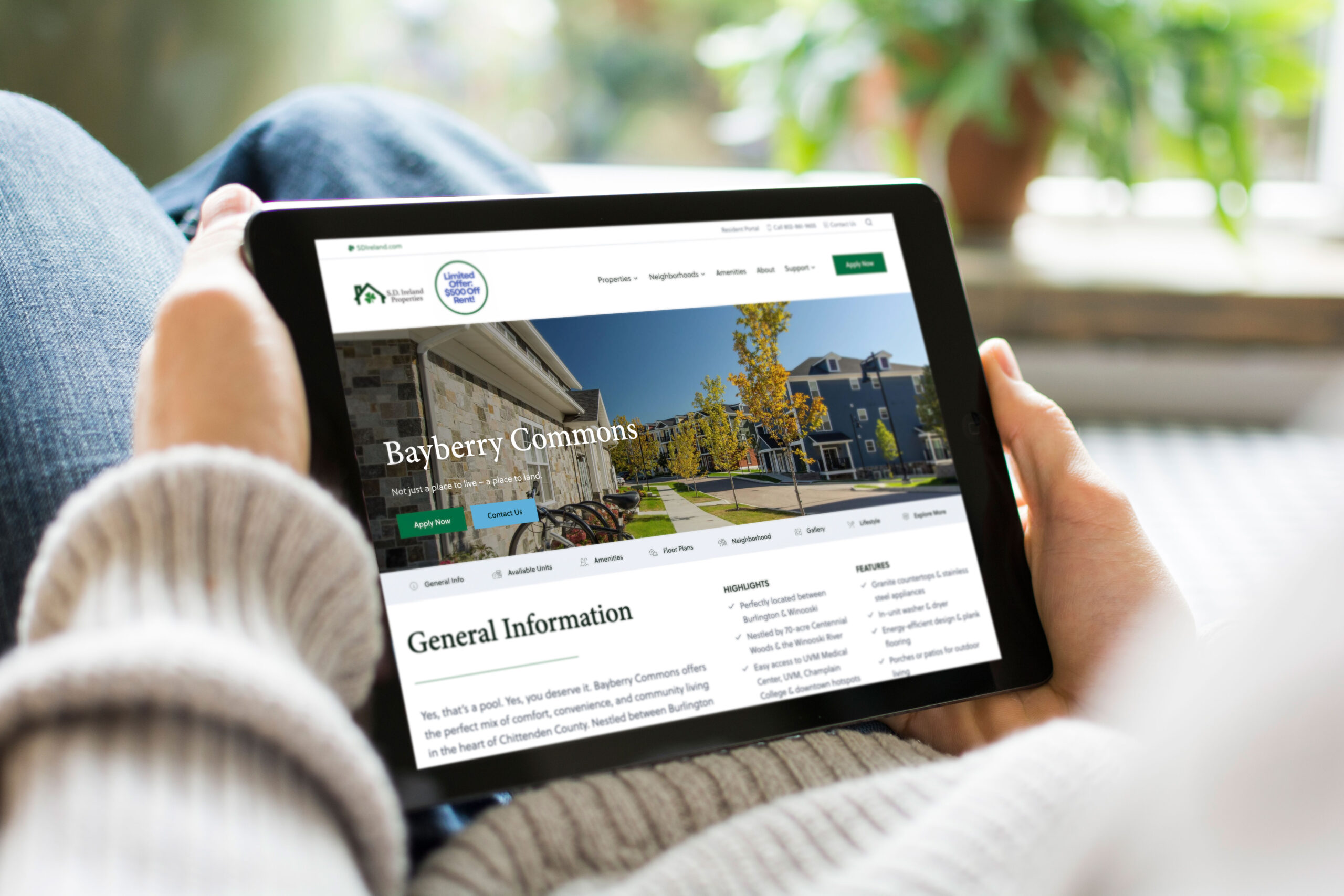 A woman holding an iPad and looking at the S.D. Ireland Properties Bayberry Commons neighborhood