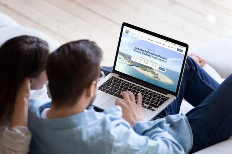 A couple browsing the new Atlantic East Nantucket Real Estate website UX