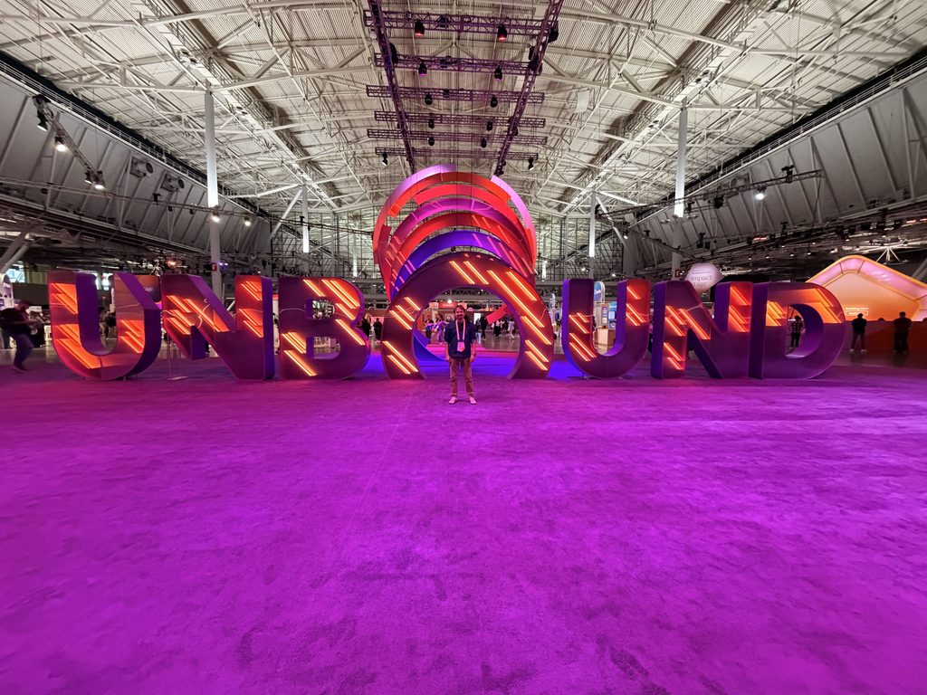 a wide angle shot of a person in front of the UNBOUND sculpture in a large exhibition hall