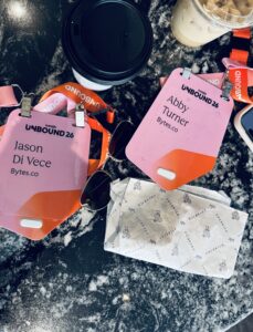A picture of coffee with Unbound conference badges on a table