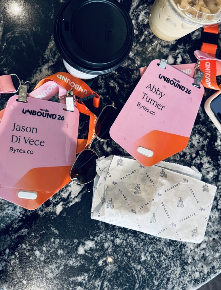 A picture of coffee with Unbound conference badges on a table